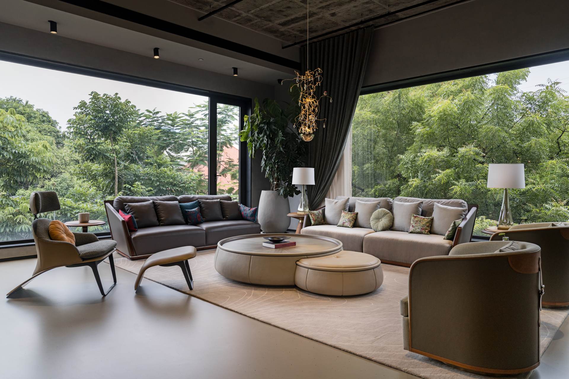 Inside the Artyk gallery — a curated living arrangement framed by floor-to-ceiling greenery